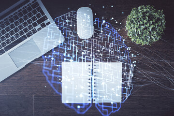 Double exposure of brain drawing hologram over topview work table background with computer. Concept...