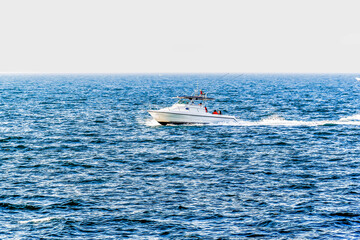 Fototapeta premium Luxury yacht speeding on arabian sea in Dubai, United Arab Emirates 