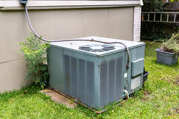 Package Air Conditioner system next to a home