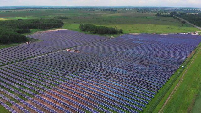 Arial Footage Of Solar Power Panels Farm. Green Energy, Renewable Energy, Alternative Energy Concept. Innovative Solar System In The Field. Drone View 4K.