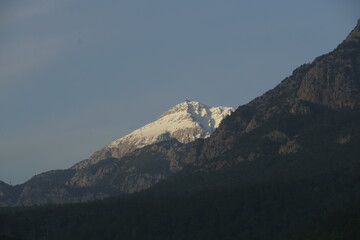 View of the mountain peaks covered with snow in sunrise