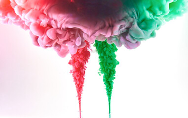 Red and green ink making clouds in water