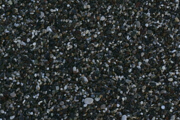 Closeup view of small stones on the beach with colorful pattern