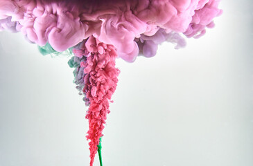 Red and green ink making clouds in water