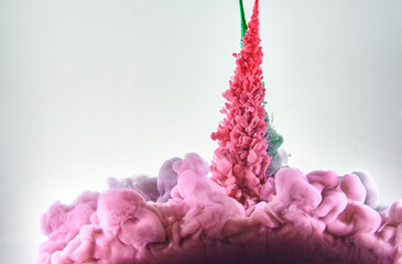 Red and green ink making clouds in water