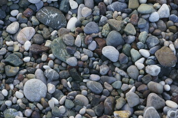 Closeup view of small stones on the beach with colorful pattern
