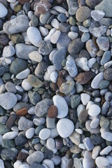 Closeup view of small stones on the beach with colorful pattern
