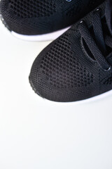 Sports black shoes and watches for monitoring your health on a white background