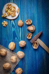 Fototapeta na wymiar still life with walnuts on a wooden background and sackcloth