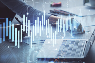 Double exposure of businesswoman hands typing on computer and forex chart hologram drawing. Financial analysis concept.