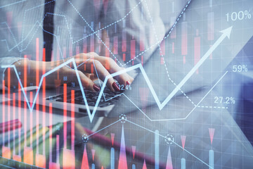 Double exposure of woman hands typing on computer and financial graph hologram drawing. Stock market analysis concept.