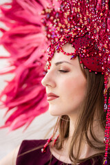 A beautiful thoughtful girl in a carnival costume looks into the distance