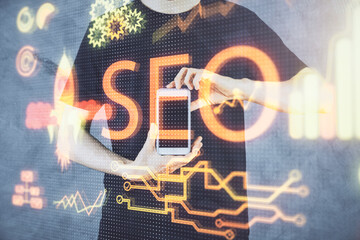 Multi exposure of man's hands holding and using a digital device and seo drawing. search...