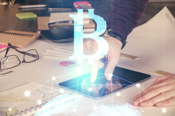 Double exposure of man's hands holding and using a phone and crypto currency blockchain theme drawing.