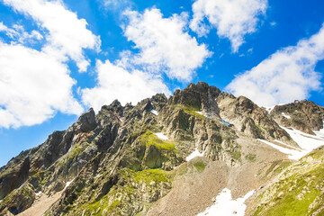 French Alps with snow in summer near Chamonix, panoramic view. Savoy tourism. Mountain trekking. Global warming, melting of snow