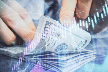 Multi exposure of forex graph drawing hologram and USA dollars bills and man hands. Technical Analysis concept.