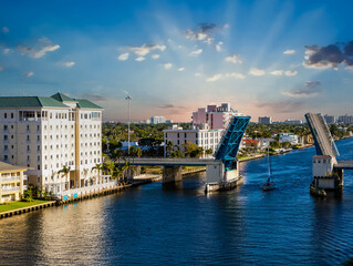 Obraz premium A Sailboat Motoring Through an Open Drawbridge in Fort Lauderdale