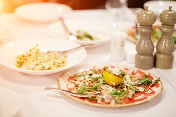 half-empty salad plates on the table. Catering