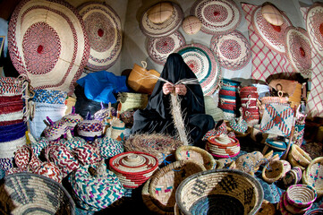 The hand of a woman working in hand made palm leaf

