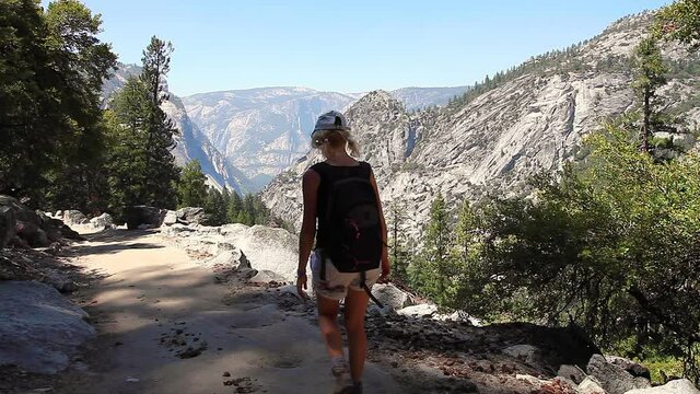 Travel hiker woman on Nevada Falls on Merced River in Yosemite National Park. Woman mountain hiker in Yosemite NP of California in United States. John Muir trail path