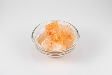 Close up photo of a glass bowl filled with Himalayan salt chunks
