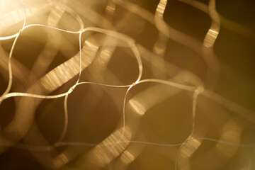 Fototapeta na wymiar Close-up view of the fishing net with warm light