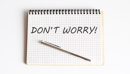 Concept DON'T WORRY message on notebook on white background