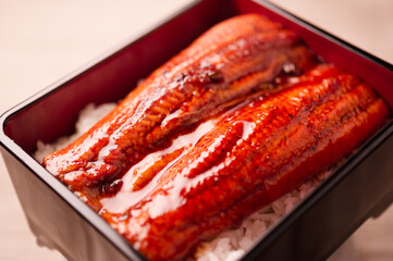 grilled fluffy shinny sweet japanese unagi eel fish kabayaki over steamed rice unaju in wood urushi lacquerware 