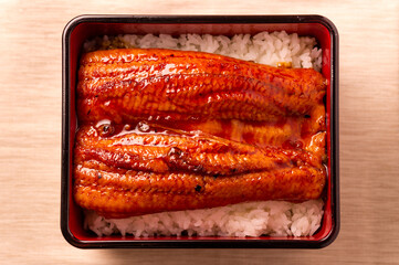 grilled fluffy shinny sweet japanese unagi eel fish kabayaki over steamed rice unaju in wood urushi lacquerware 