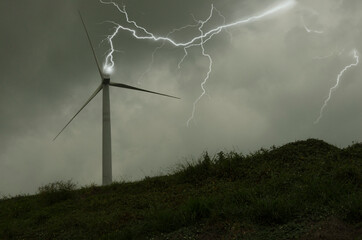 Dangerous lightning on wind turbine on the hill