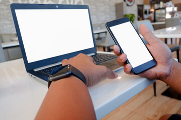 Cropped shot view of man’s Hands hold the smartphone with blank copy space screen for your information content or text message on the gray granite at the modern place.