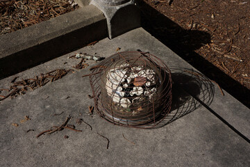 Vintage antique eternal wreath on a dilapidated grave.