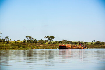 Fototapeta premium Guaraci, Sao Paulo, Brazil, April 08,2015. Boat extracts sand on the edge of an arm of Rio Grande on the border of the states of Sao Paulo and Minas Gerais, in the municipality of Guaraci