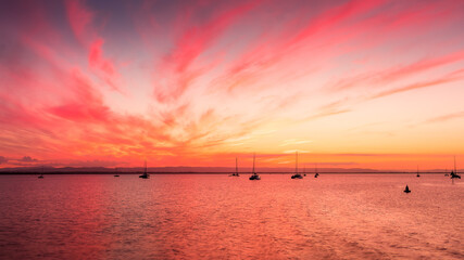 sunset over the sea at Scarborough Marina Queensland with boats in the foreground