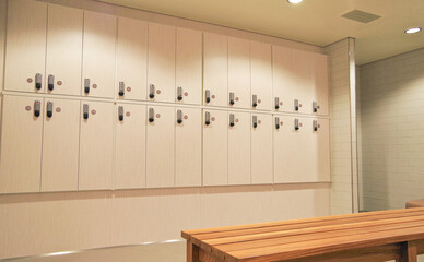 View into mens locker or changing room inside spa or wellness area with lockers and shower on...