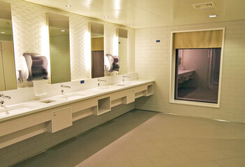 View into mens locker or changing room inside spa or wellness area with lockers and shower on...