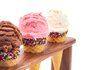 Scoops Classic Vanilla Strawberry and Chocolate Ice Cream Flavors in Sugar Cones with Sprinkles