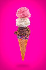 An Ice Cream Cone with Strawberry Vanilla and Chocolate in a Pointed Sugar Cone Floating in the Air
