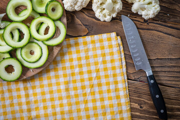 Fresh vegetables zucchini and cauliflower are sliced on a cutting Board.