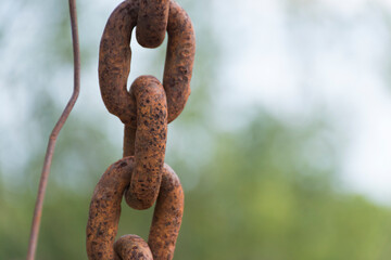 Rusty chains taken close-up portrait, blurry back