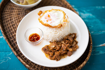 Fried Pork with Garlic, Pepper and fried egg on rice. Easy thai food.