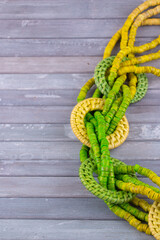 Obraz premium Close Up Handmade multi colour bead necklace - ranging green and yellow with copy space 