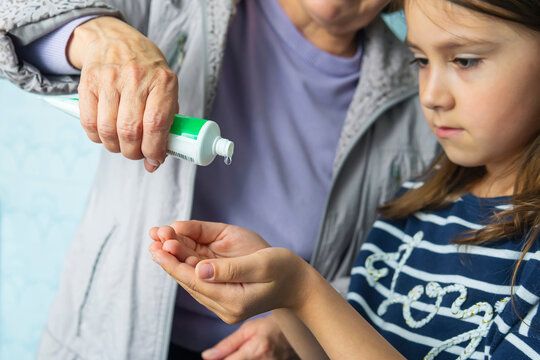 child girl using alcohol antiseptic gel, prevention, cleaning hands frequently, prevent infection, outbreak of Covid-19 girl wash hands with hand sanitizer