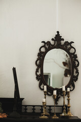 Antiques. Old candles and a mirror. Beautiful interior in the apartment
