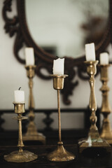 Antiques. Old candles and a mirror. Beautiful interior in the apartment
