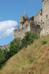 Fototapeta na wymiar Carcassonne castle side view, Carcassonne Provence, France, side view of the castle from the side of the hill in a sunny day in Provence. Middle age castle UNESCO.