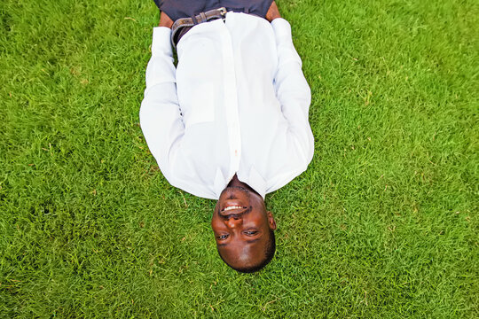 Black Man Lying Down On A Grass