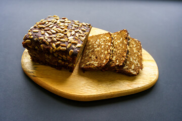 Loaf of black bread with seeds, cut into pieces