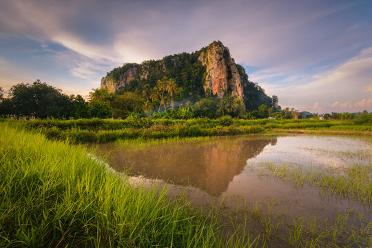 beautiful reflection of the famed historical Keriang Hill with paddy rice field on foreground minutes before sunset. Keriang Hill is located near Alor Setar, the capitalcity of Kedah.
