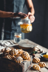 Man pours Hot tea with slices of fresh grapefruit on wooden tablet. Healthy drink, Eco, vegan.